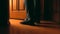 Adult man stands near door to a bathroom at the night