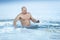 Adult man swimming icy winter water