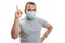 Adult man wearing surgical or medical mask making idea gesture