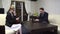 Adult man and woman in business dress sitting in light room and working