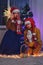 An adult man and a woman play a homemade puppet show at the Christmas tree