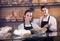 Adult man and woman selling pastry and loaves