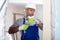 Adult man worker renovating with drill in gloves