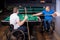 Adult men with disabilities in a wheelchair play billiards in the club