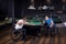 Adult men with disabilities in a wheelchair play billiards in the club