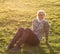 Adult, nice woman sitting on grass meadow