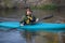 Adult paddler in blue kayak