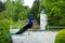 The adult peacock is standing on a wall