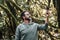 Adult people caucasian man in the forest looking for internet phone call signal - modern people enjoying outdoor leisure activity