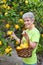 Adult picking lemons from tree