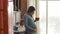 Adult pregnant woman strokes the belly and holds a red cup