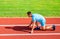 Adult runner prepare race at stadium. How to start running. Sport motivation concept. Man athlete runner stand low start