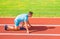 Adult runner prepare race at stadium. How to start running. Sport motivation concept. Man athlete runner stand low start