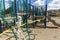 Adult skeleton sitting on playground equipment at an empty closed park on a nice day