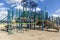 Adult skeleton sitting on playground equipment at an empty closed park on a nice day