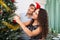 Adult smiling couple decorating Christmas tree