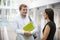 Adult student and teacher talking in university foyer