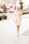 Adult stylish woman walking in the street