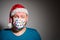 Adult surprised man in Christmas decorated mask celebrate xmas holidays at home because coronavirus.