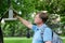 An adult tall blond man pours bird food into