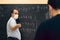 Adult teacher wearing mask explaining mathematical lessons to a student. Covid situation, pandemic, new normal