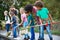 Adult Team Leaders Show Group Of Children On Outdoor Activity Camp How To Catch And Study Pond Life