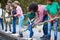 Adult Team Leaders Show Group Of Children On Outdoor Activity Camp How To Catch And Study Pond Life