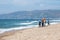 Adult tourists take selfies and photos, posing with umbrella props while enjoying the