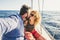 Adult traveler couple in love on a sail boat - people enjoying the summer holiday vacation doing a trip - outdoor leisure activity