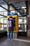 Adult using an automated ticket machine to purchase travel tickets in entrance to railway station