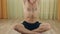 Adult white man relaxing in lotus posture and meditates. Indoors Yoga Individual exercise.