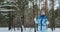 An adult woman of 60 years old walks in a winter park outdoors on skis