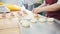 Adult woman bakes and forming meat pies in the bakery