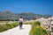 Adult woman is biking at Favignana Island, Italy