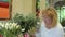 Adult woman choose flowers in flower shop