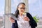 Adult woman drinks water with lemon, female in glasses with digital tablet