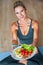 Adult woman eating healthy lunch and sitting on yoga mat