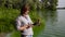 Adult woman ecologist examines sample of green algae and enters data on tablet
