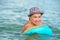 ADULT WOMAN IN A HAT SWIMS IN SEA