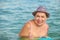 ADULT WOMAN IN A HAT SWIMS IN SEA