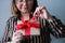 Adult woman holds box with gift, concept of love, tender relationship of couple in love, birthday, valentine`s day, mother, merry