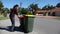 Adult woman household taking out bin to the street