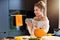 Adult woman in the kitchen preparing pumpkin dishes for Halloween