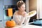 Adult woman in the kitchen preparing pumpkin dishes for Halloween