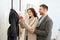 Adult woman and man checking price in shopping mall