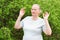 Adult woman meditates outdoors.