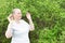 Adult woman meditates outdoors.