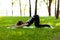 Adult woman practices yoga in park in morning, health promotion, relaxation