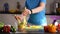 Adult woman preparing vegetable salad in kitchen