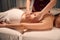 Adult woman receiving relaxing body massage at spa salon